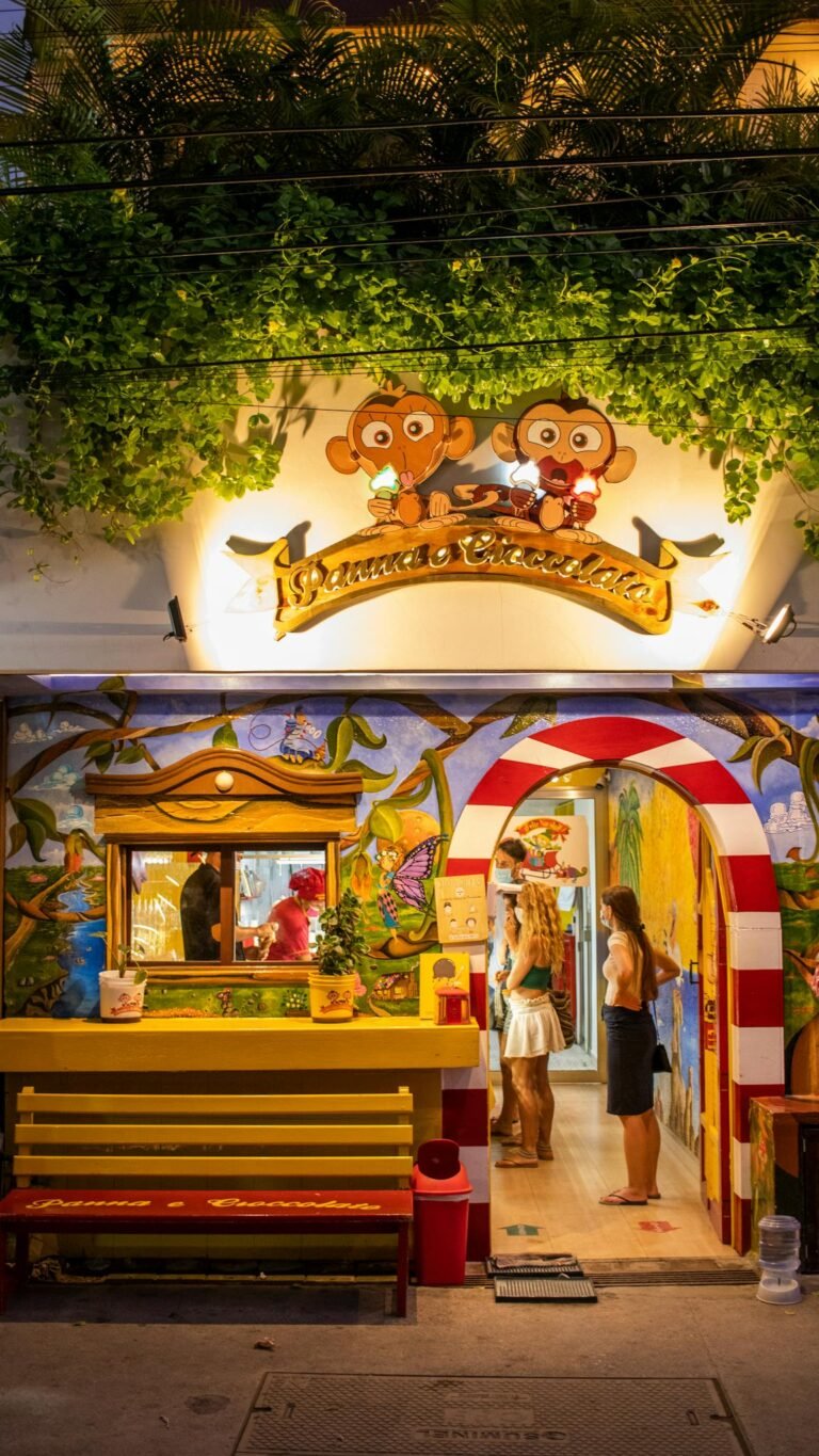 Colorful facade of a lively food stall in Tulum, Mexico showcasing artistic decor and vibrant street life at night.